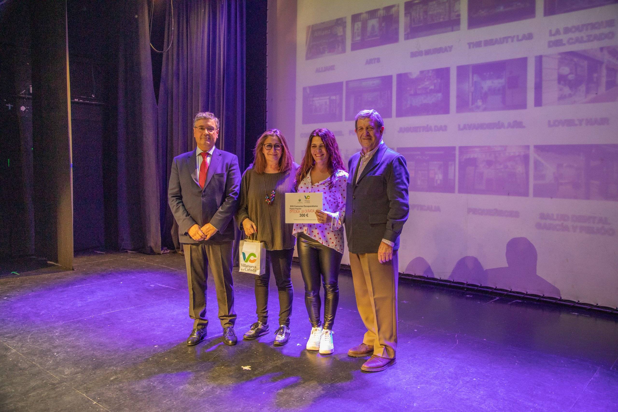 El alcalde, Luis Partida, y el concejal de Desarrollo Local, Juan Miguel Gómez, entregando el premio a las representantes de "Opticalia la Cañada".