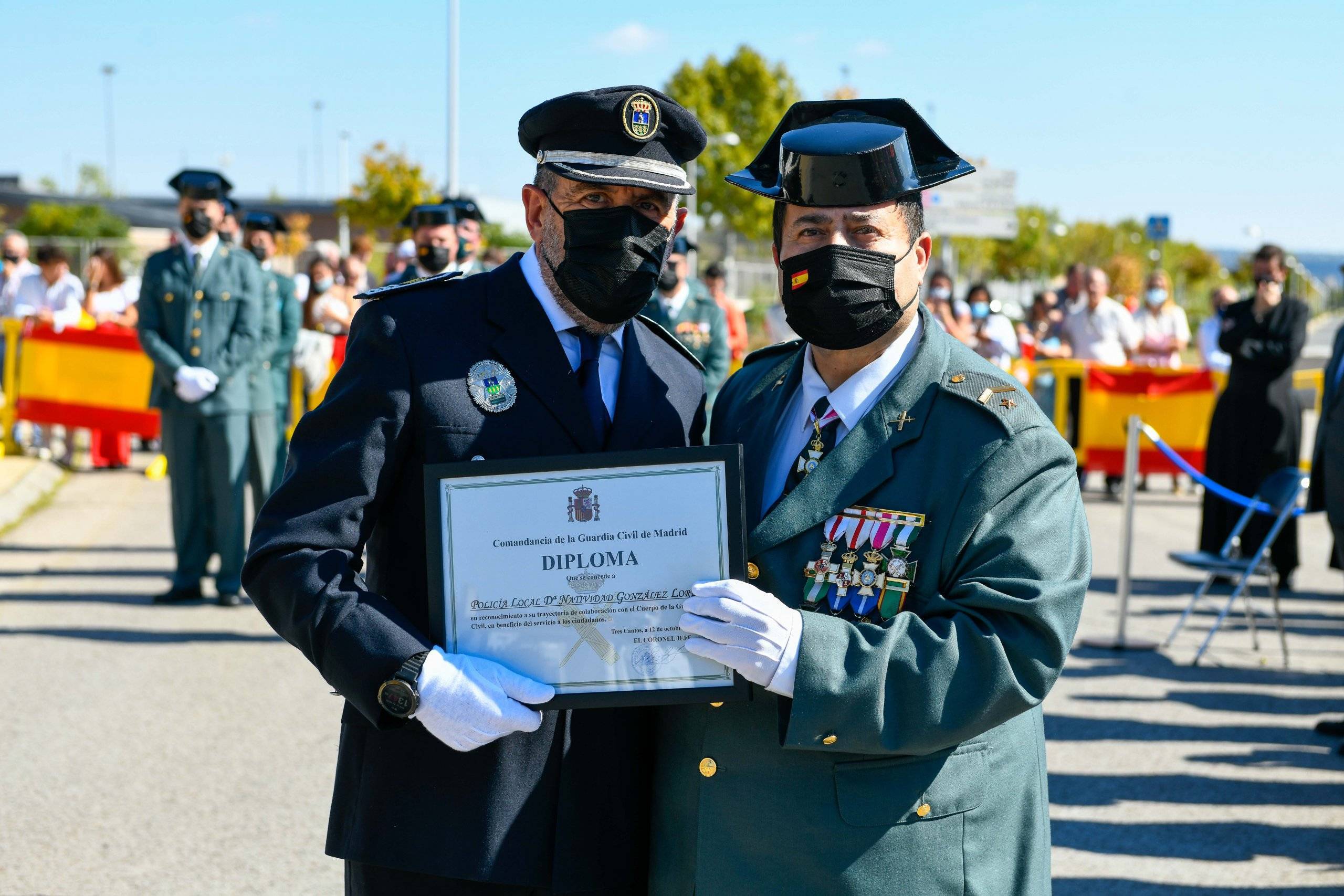 El inspector de Policía Local recoge de manos del subteniente jefe de la Guardia Civil el diploma concedido a una agente de Policía Local.