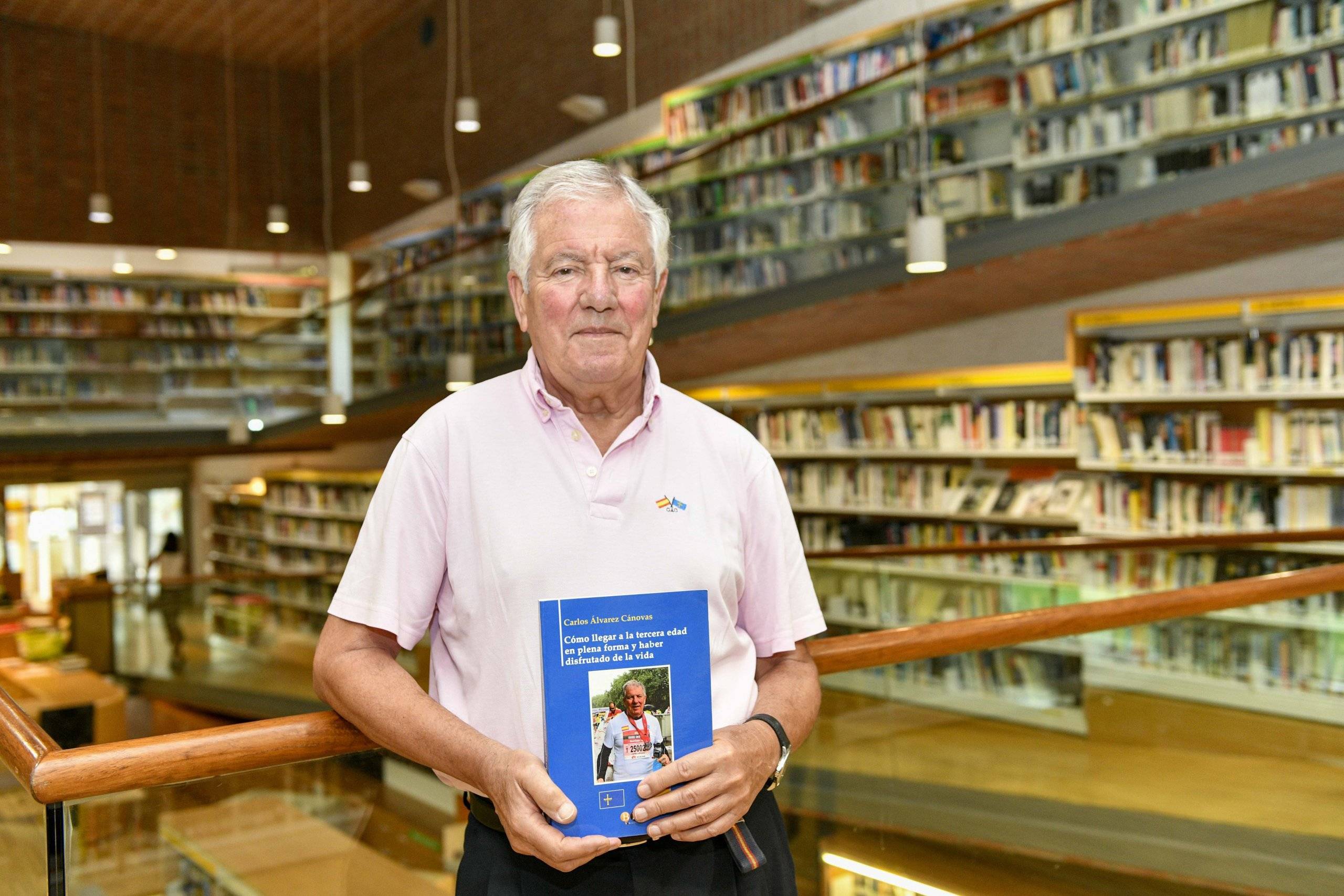 El autor local Carlos Álvarez, con su libro en la Biblioteca Municipal.